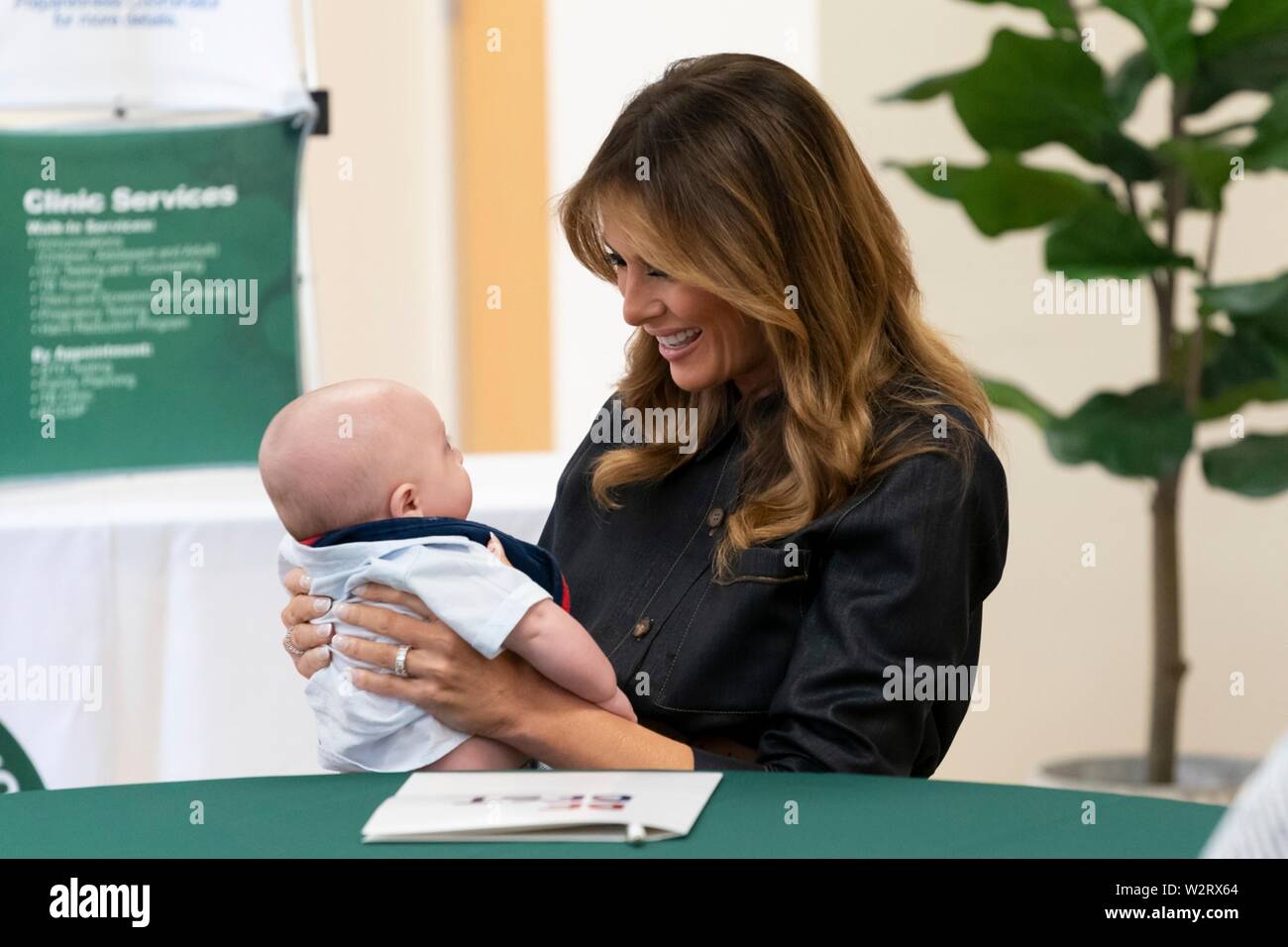 U.S First Lady Melania Trump holds Huck, the 5-month-old son of Megan  Pawley, a mother in recovery, during a discussion on addiction at the  Cabell-Huntington Health Department July 8, 2019 in Huntington,