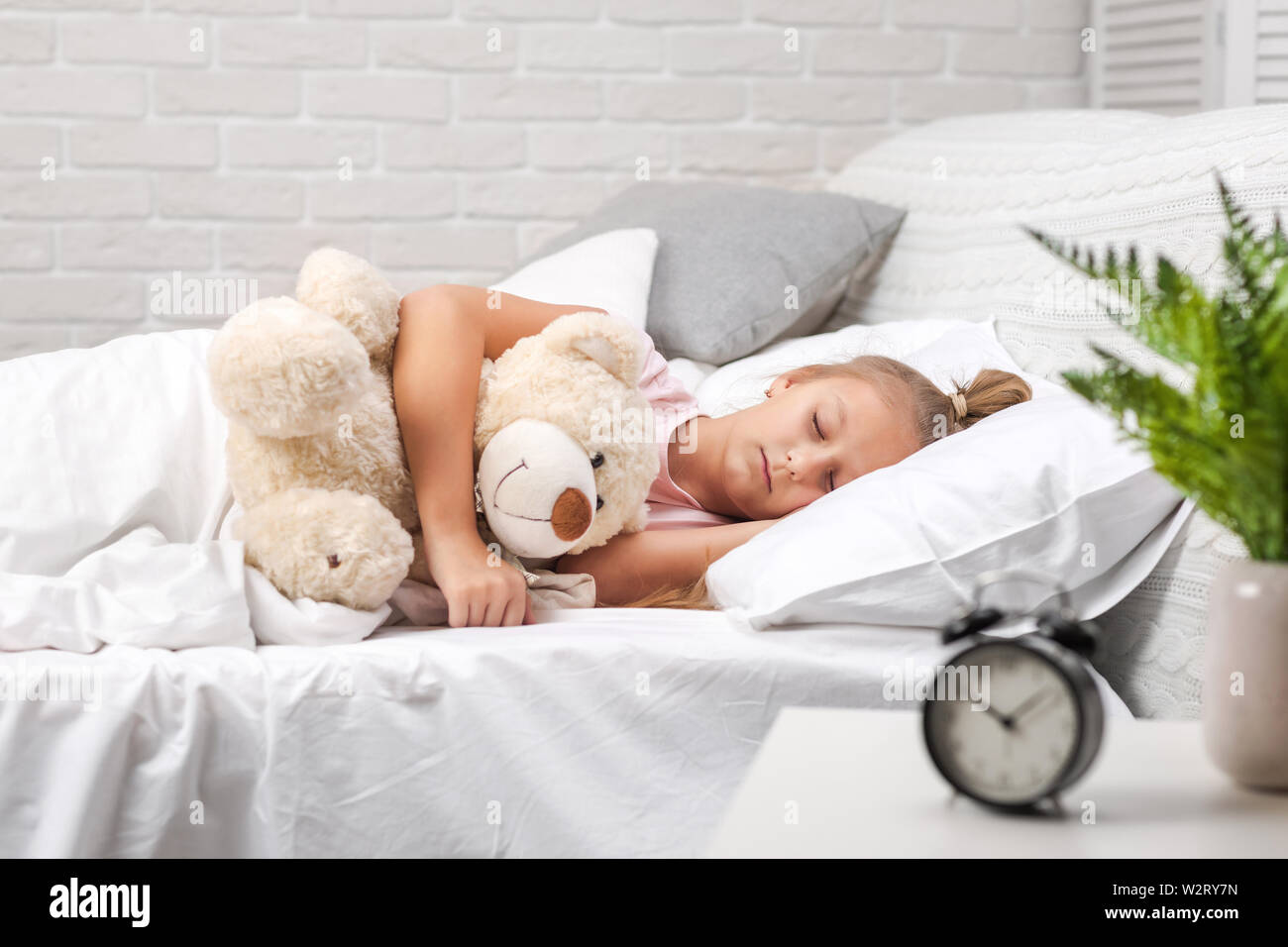 Cute little child girl sleeping with teddy bear in her bed Stock Photo ...