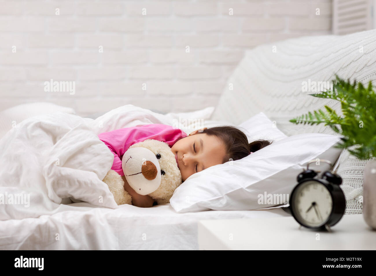 Cute little child girl sleeping with teddy bear in her bed Stock Photo ...