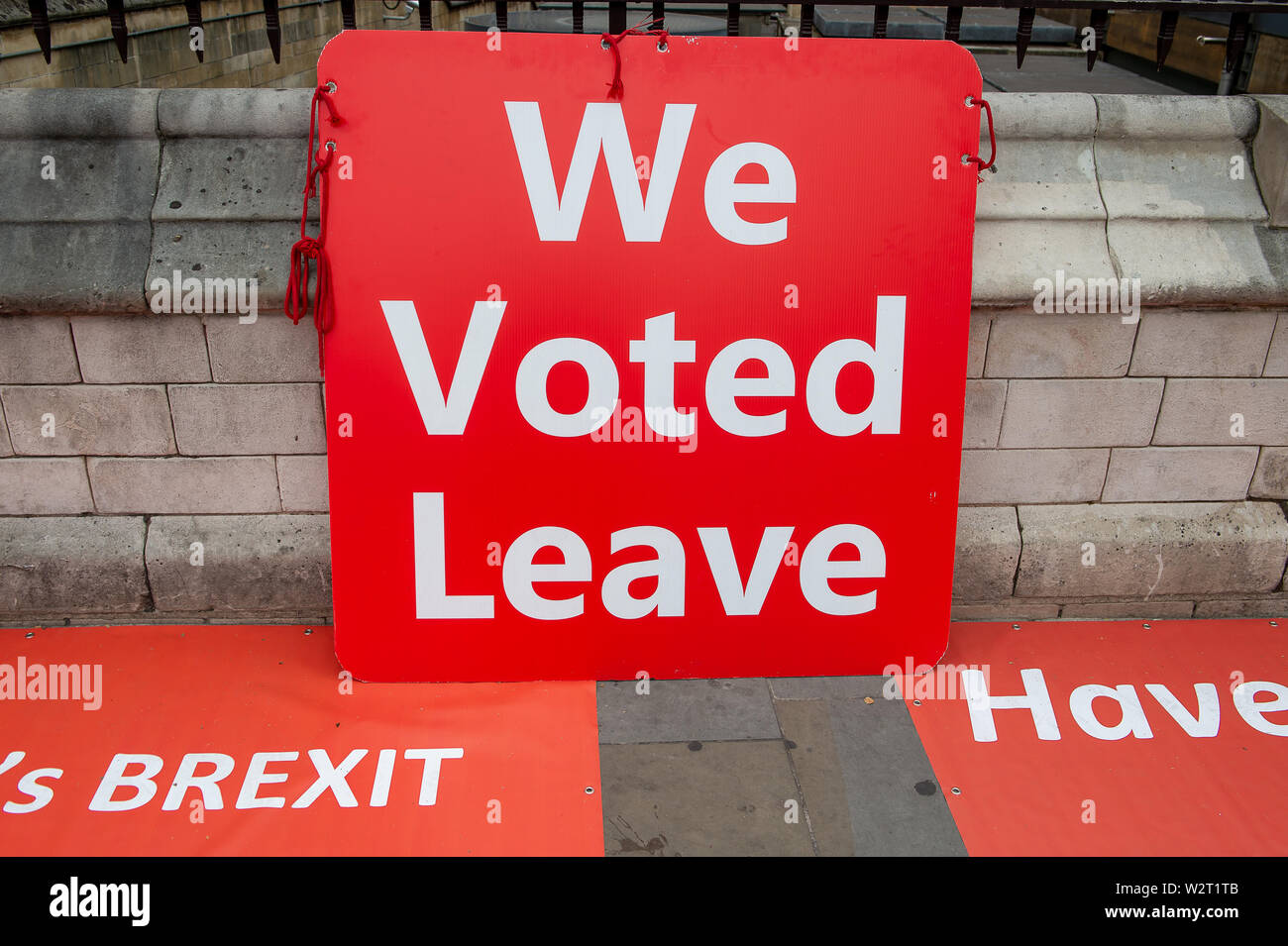 Pro Brexit Campaign, Westminister, London. 9th July, 2019. A Pro Brexit We Voted Leave red campaign sign leans against the walls of the Palace of Westminister. Credit: Maureen McLean/Alamy Stock Photo