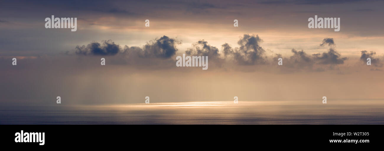 Panorama of ocean reflections and clouds near sunset on Pacific Ocean in South Kona, Hawaii Stock Photo