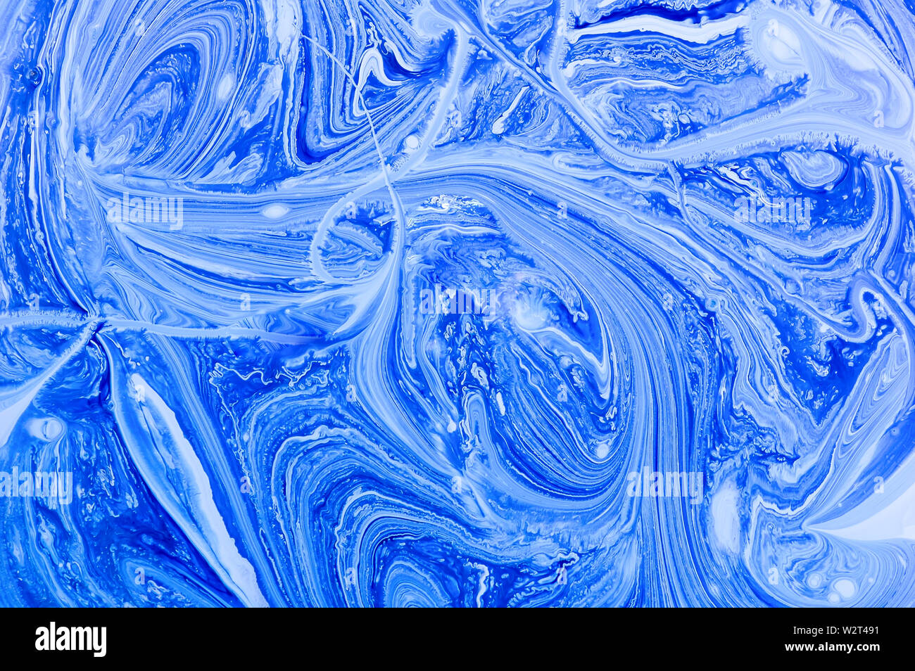 Blue abstract background with marble pattern. Marble liquid acrylic texture. White and blue acrylic paints. Fluid art-marble effect. Stock Photo