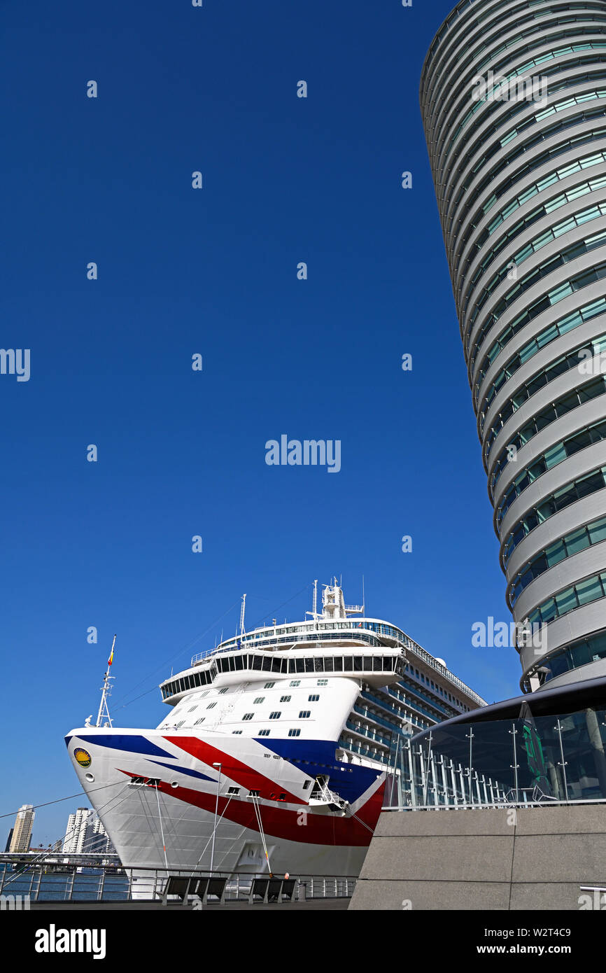 rotterdam, netherlands - april 01, 2019:  the british cruise vessel britannia (imo # 9614036) berthed at cruise terminal kop van zuid in front of port Stock Photo