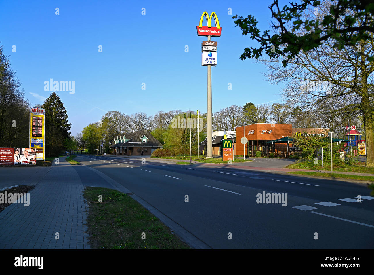 papenburg, germany - april 17, 2019:  main thoroughfare into and out of this city of papenburg, a petrol station, real estate agent office, mcdonalds Stock Photo