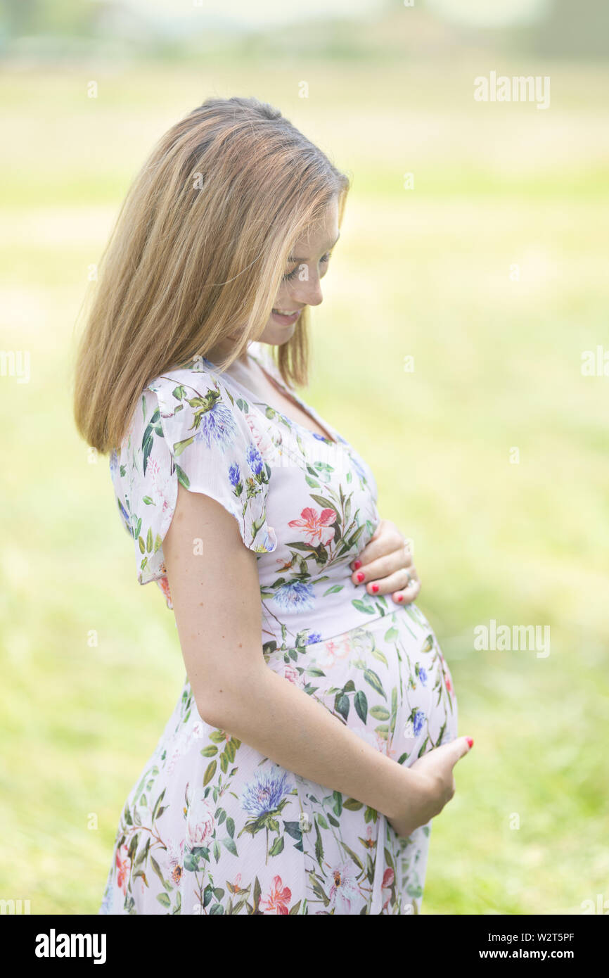 Pregnant girl in white dress hi-res stock photography and images - Alamy