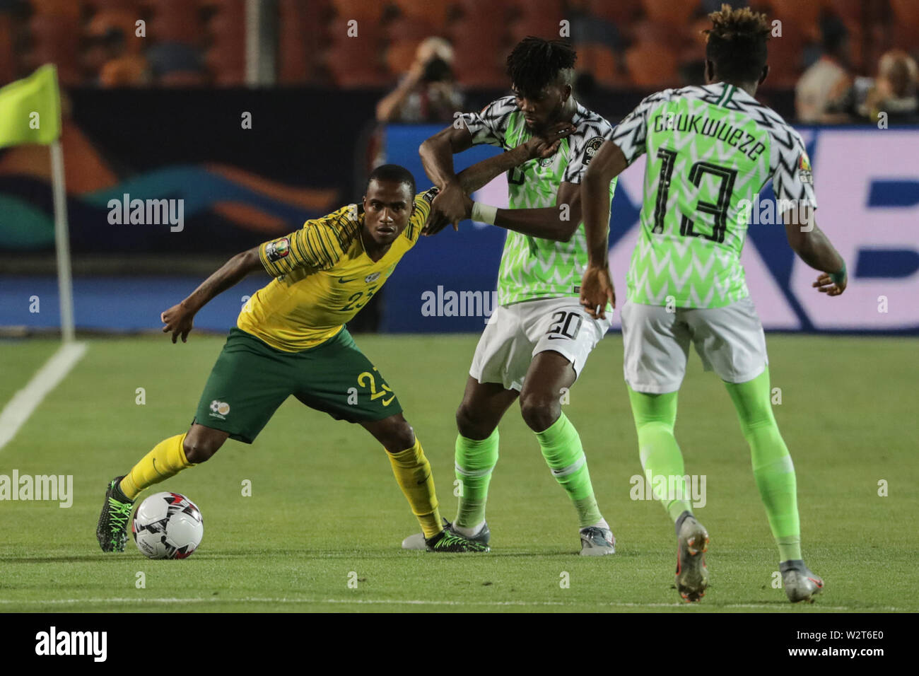 Cairo, Egypt. 10th July, 2019. South Africa's Thembinkosi Lorch (L) battles for the ball with Nigeria's Chidozie Awaziem (C) and Samuel Chukwueze during the 2019 Africa Cup of Nations quarter final soccer match between Nigeria and South Africa at the Cairo International Stadium. Credit: Oliver Weiken/dpa/Alamy Live News Stock Photo