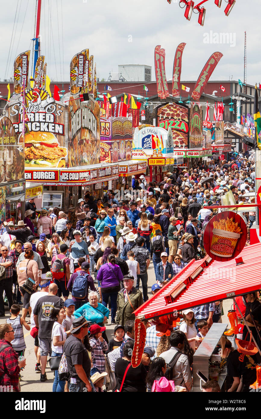 CALGARY, CANADA - July 9, 2019: A crowd filled the street on Olympic Way SE at the annual Calgary Stampede event. The Calgary Stampede is often called Stock Photo