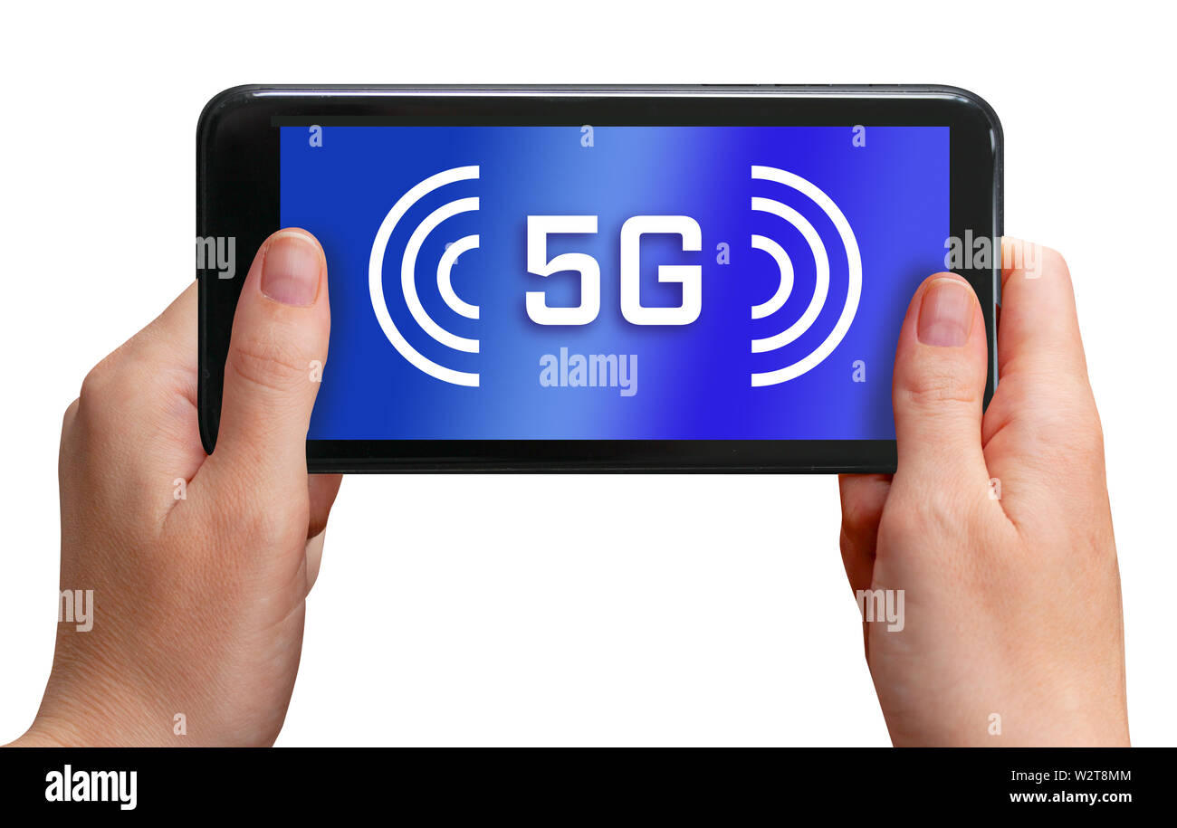 Two hands holding cell phone with screen showing 5G and wireless internet symbol on the display. Isolated on white background. Stock Photo