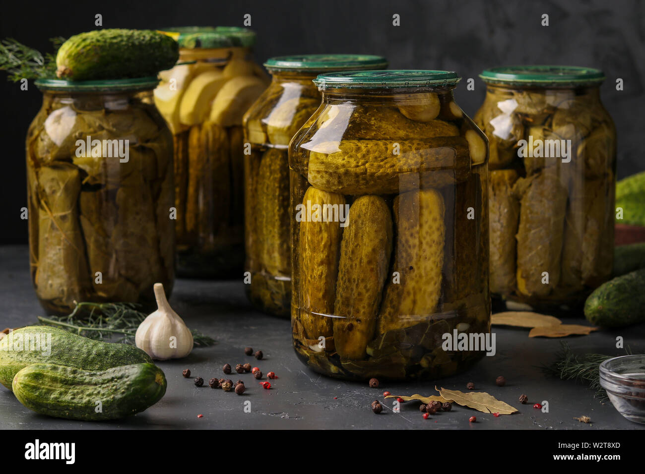 Different Pickled Cucumbers With Zucchini Garlic And Grape Leaves In Jars On A Dark Background Horizontal Photo Stock Photo Alamy