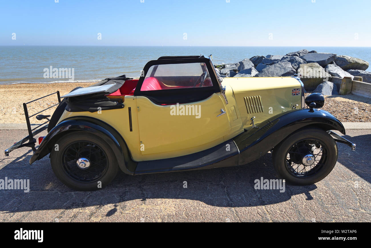 Vintage Black and Cream Motor Car Parked on Seafront Promenade. Stock Photo
