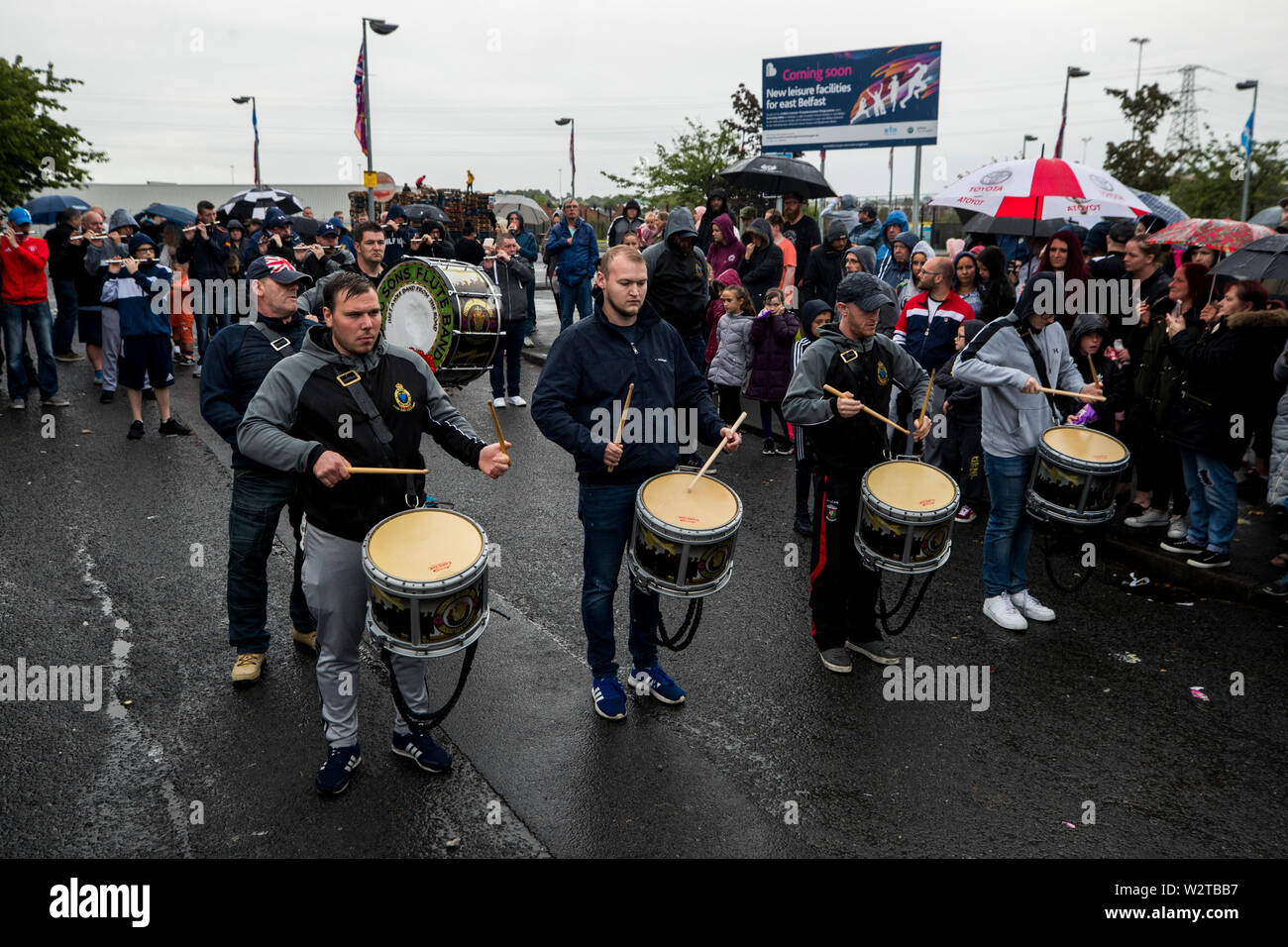 Bandsmen from the Rising Sons Flute Band play tunes at the site of the 11th night bonfire at Avoniel Leisure Centre in Dublin, Northern Ireland, as organisers host a “family fun day” after Belfast City Council reaffirmed its decision to remove materials from a bonfire site beside the centre. Stock Photo