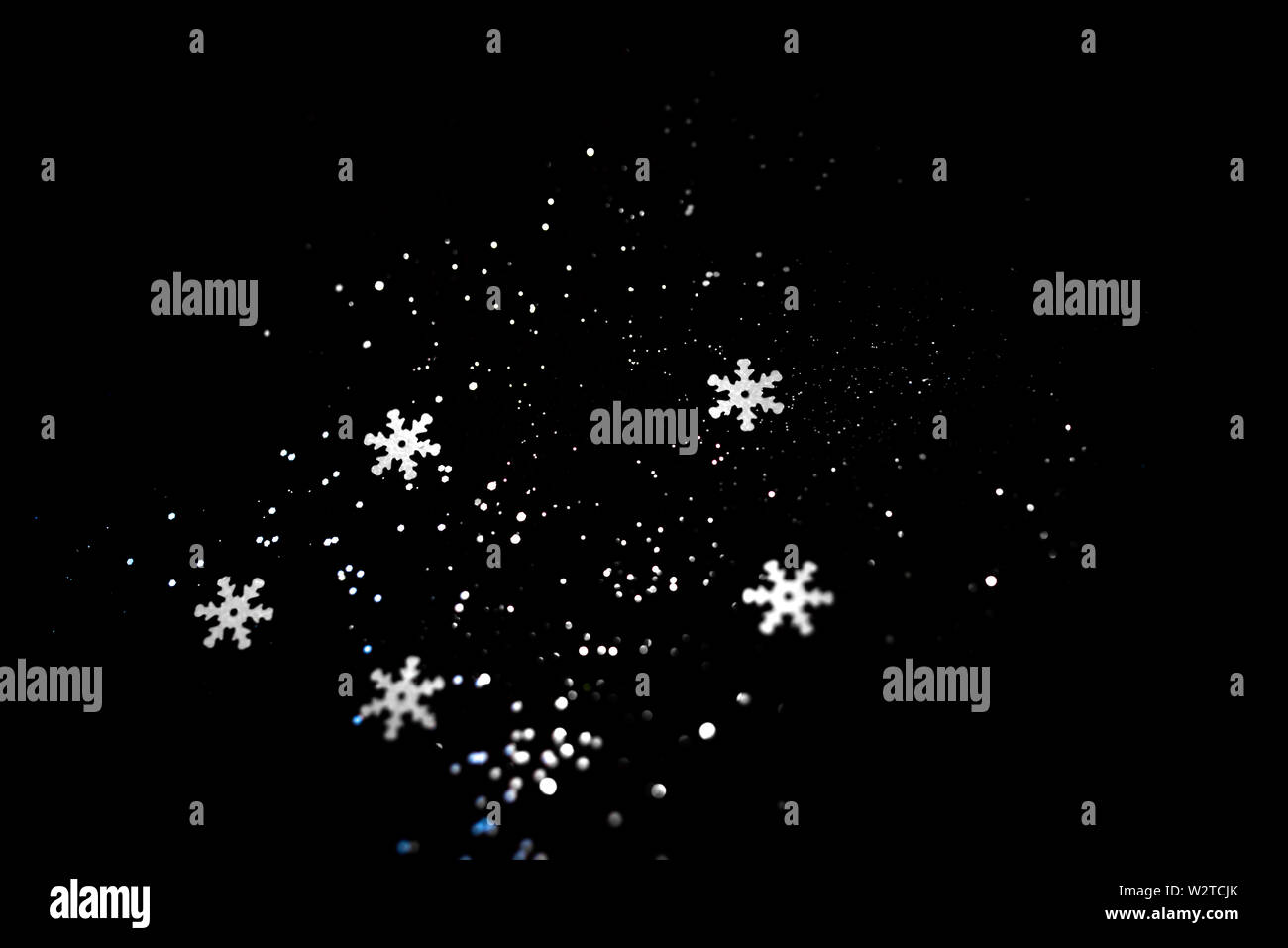 Abstract black background with isolated snowflakes Stock Photo - Alamy