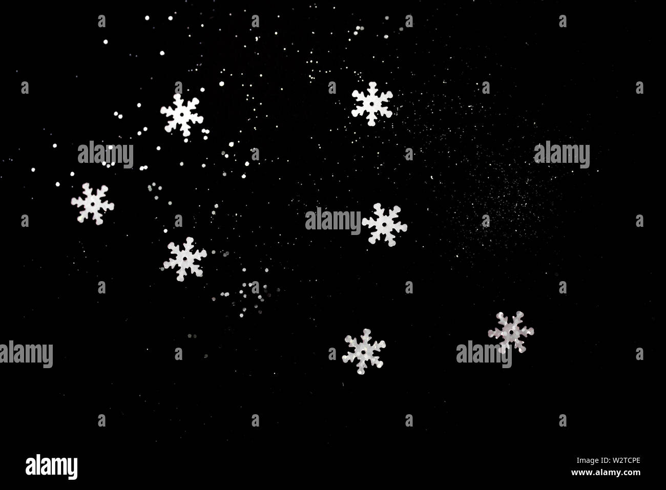 Abstract black background with isolated snowflakes Stock Photo - Alamy