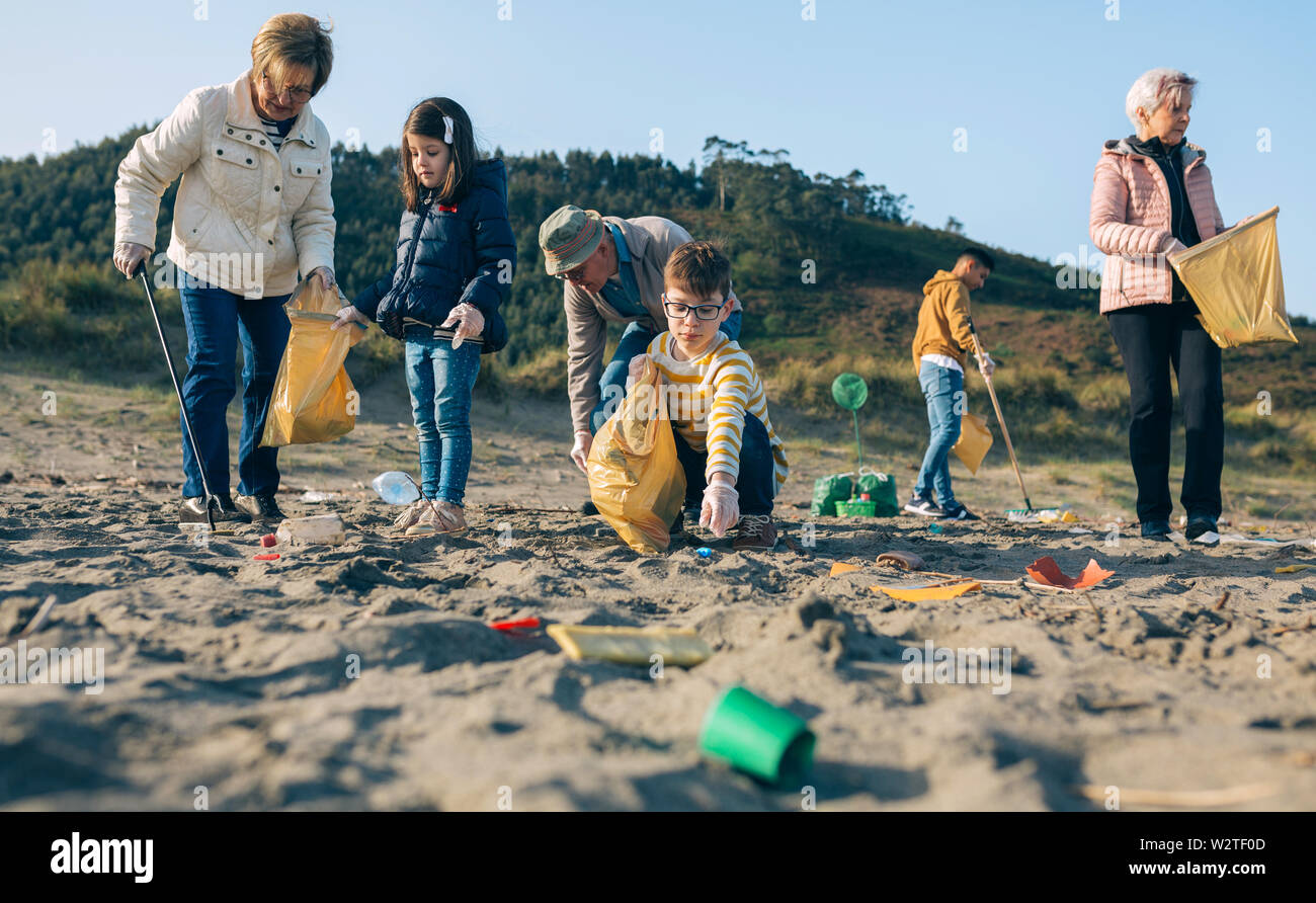 Volunteers cleaning the beach Stock Photo Alamy