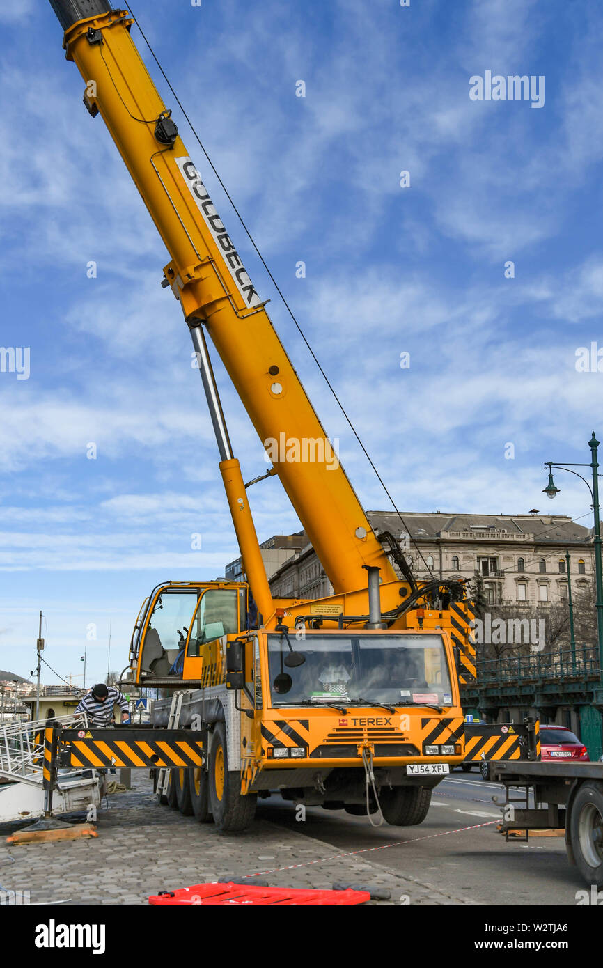 BUDAPEST, HUNGARY - MARCH 2018: Wide angle view of a large mobile crane with telescopic jib extended on the riverfront in Budapest. Stock Photo