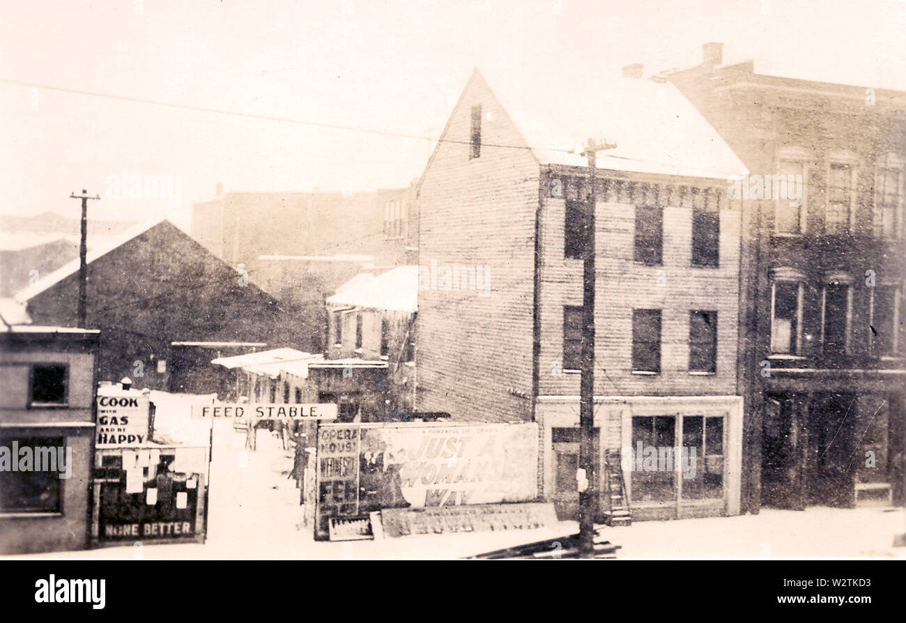 The subsequent site of Englert Theatre in downtown Iowa City, Iowa, shown before 1888. The light building is Schaffer Hotel, with the open space and the area behind the hotel occupied by Foster, Graham & Schaffer livery stable. There is some doubt as to the spelling of the latter name, with a 1904 advertisement showing it as Shaffer while the same directory containing the ad gives a personal listing for E.C. Schaffer as associated with the livery. Extensive review produces no conclusion from local histories of Hiram Reid (1883 county history), Ray Aurner (1912 county history, Irving Weber (197 Stock Photo