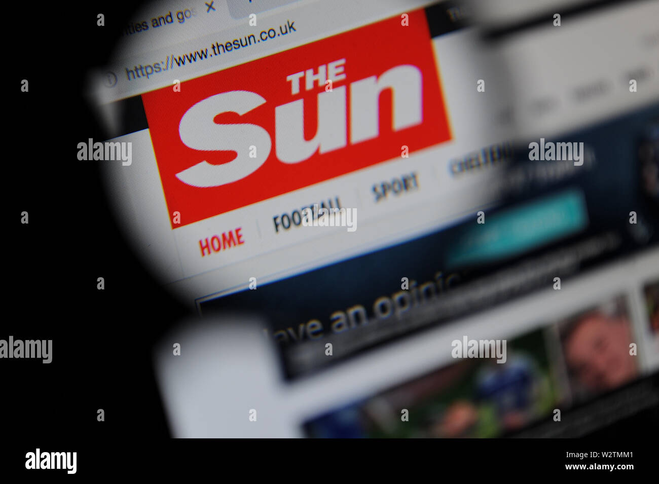 The Sun website seen through a magnifying glass Stock Photo