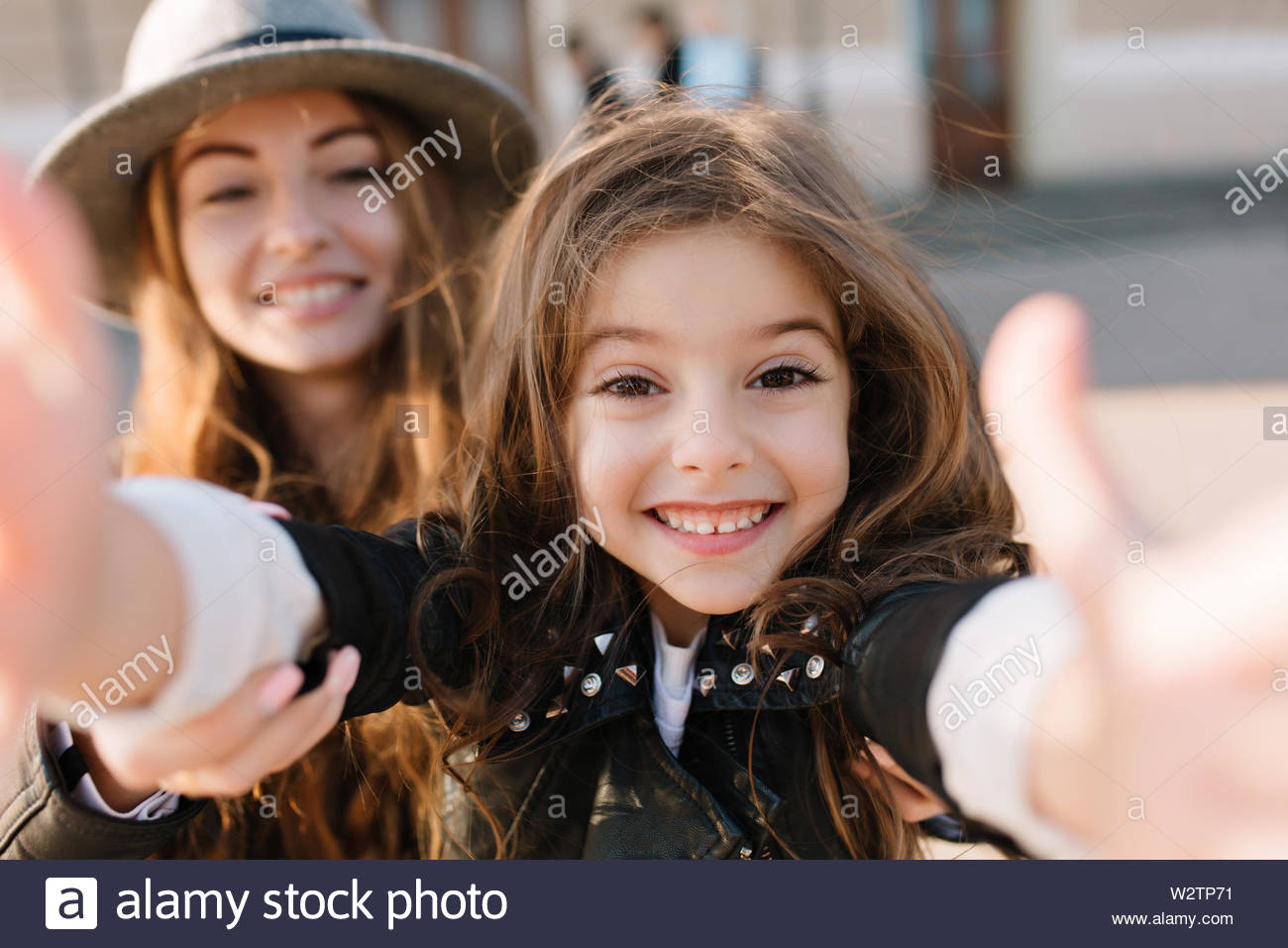 Cheerful Little Girl With Big Brown Eyes Making Selfie Standing In