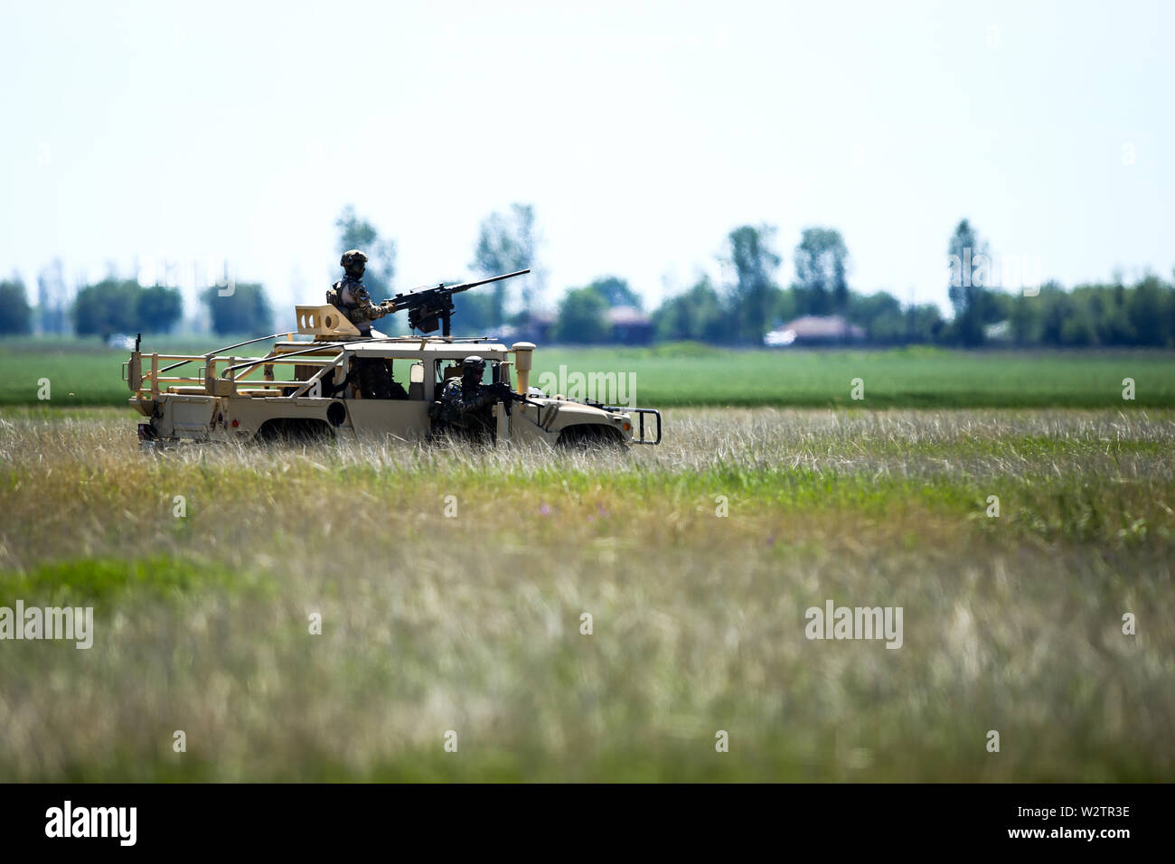 Boboc, Romania - May 22, 2019: Romanian soldiers man a Humvee armored vehicle on a field, on a sunny summer day during a drill. Stock Photo