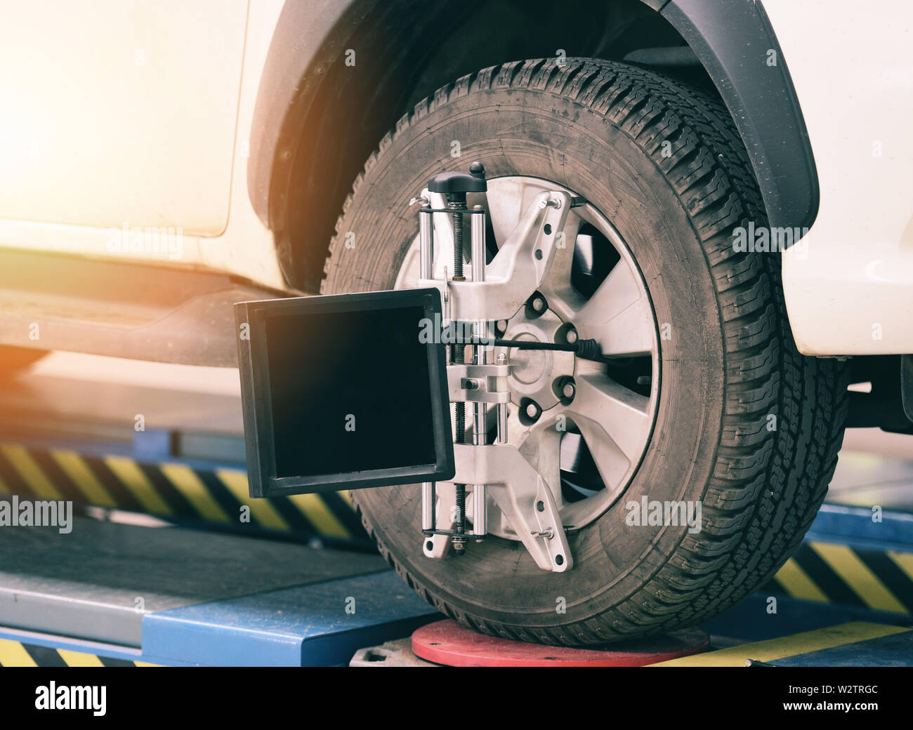 Wheel alignment equipment car mechanic installing sensor suspension