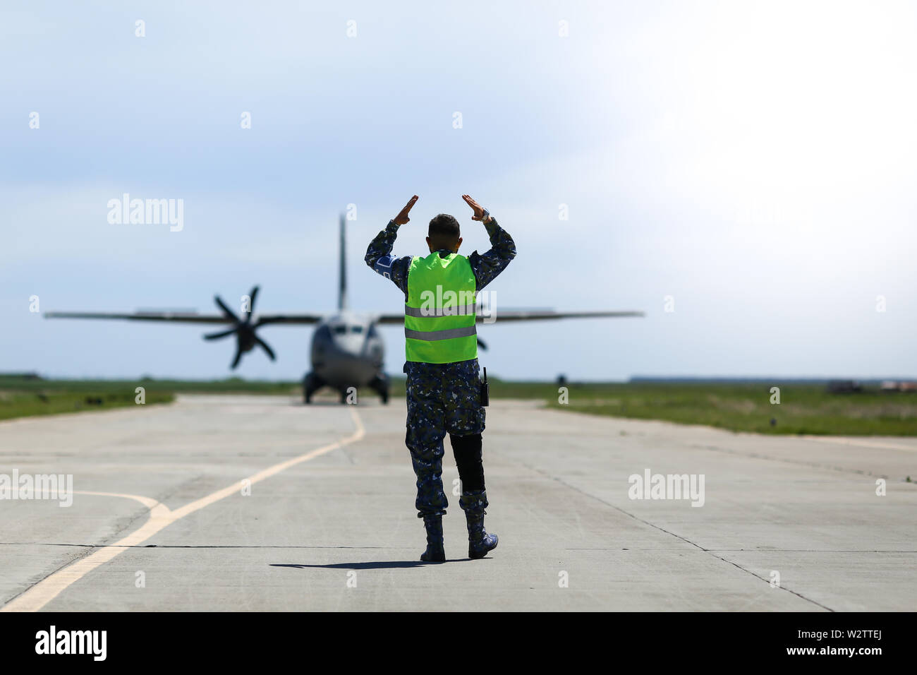 Boboc, Romania May 22, 2019 Ground personnel is aircraft marshalling