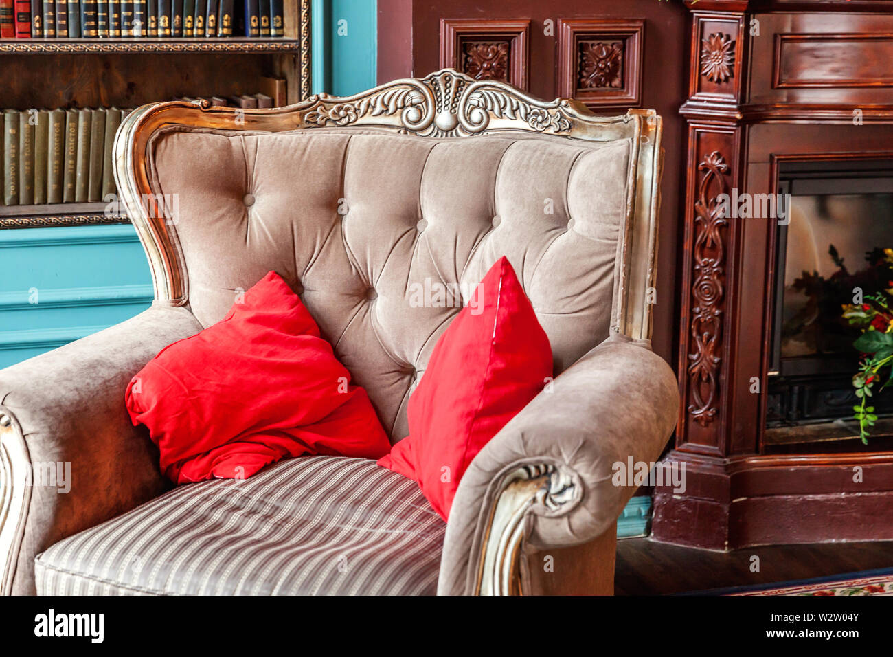 Luxury classic interior of home library. Sitting room with bookshelf,  books, arm chair, sofa and fireplace. Clean and modern decoration with  elegant f Stock Photo - Alamy
