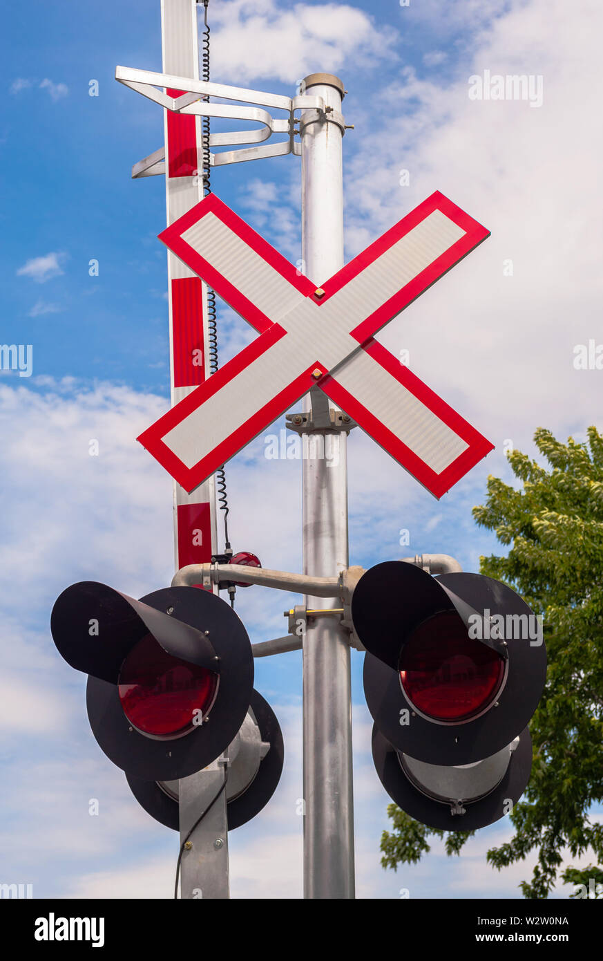 Railway crossing signals and barrier. Stock Photo