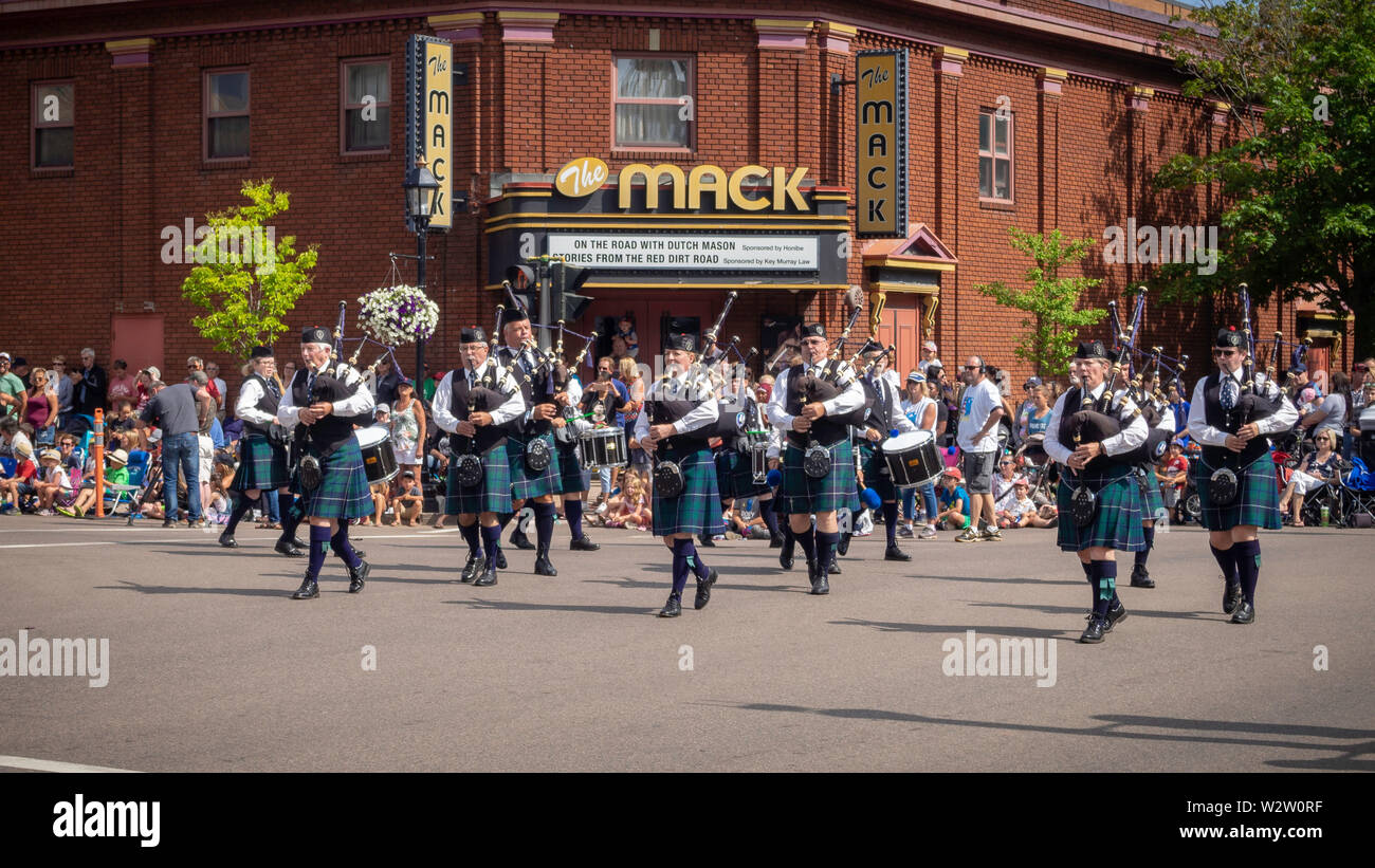 Members of the Pipe and Drum band march down the street in Gold Cup