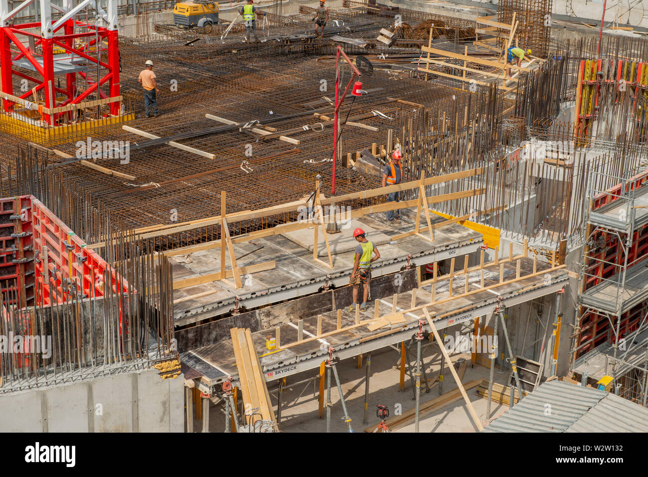 milan italy 29 june 2019: Workers at work in the construction of the bases of the base of the nest vertical a futuristic building in the business dist Stock Photo