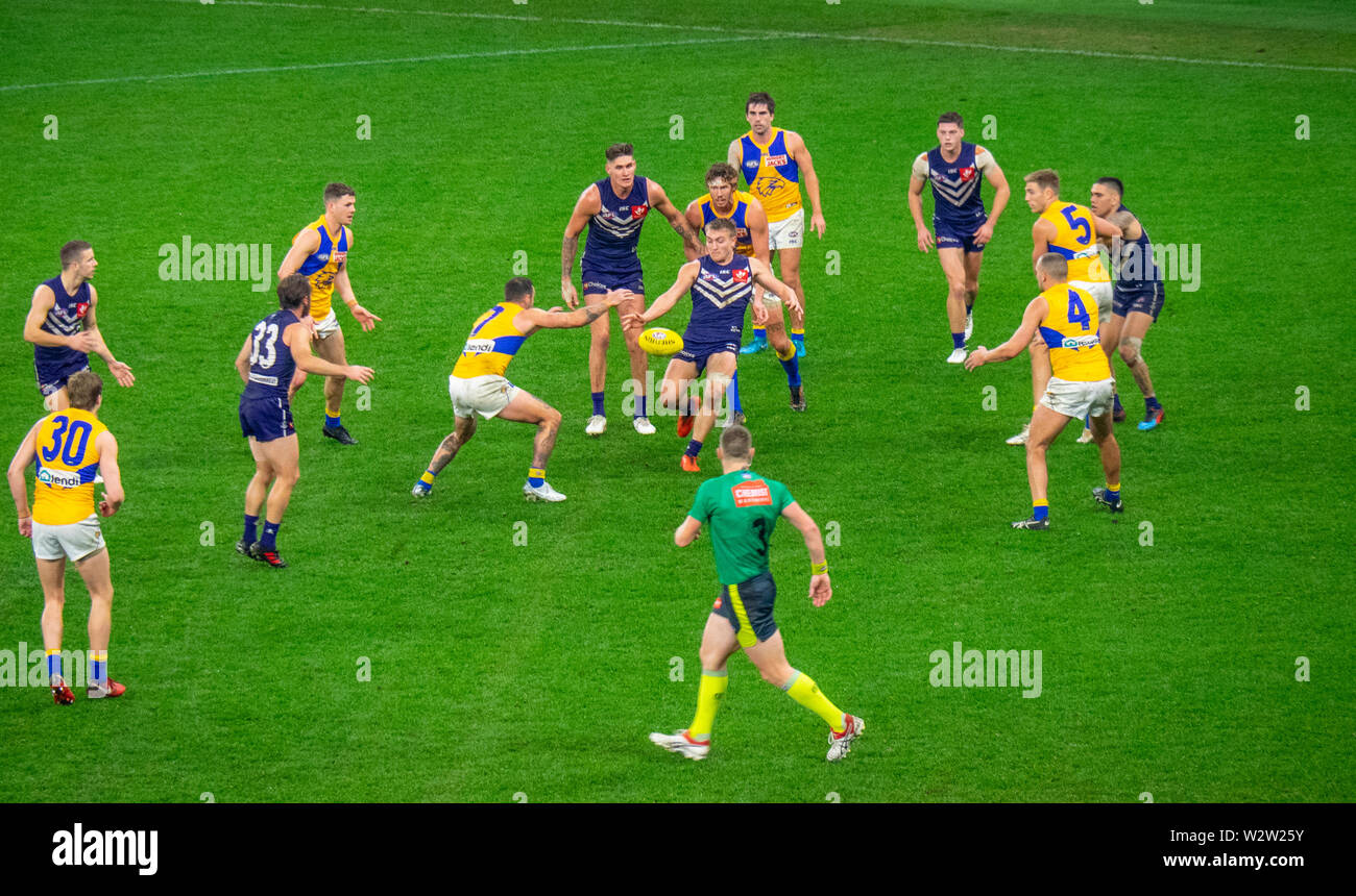 West Coast Eagles and Fremantle Dockers football players in Western Derby AFL game at Optus Stadium Perth Western Australia. Stock Photo