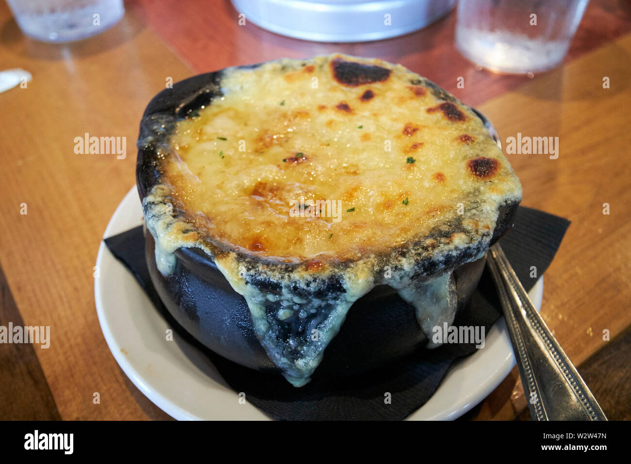 bowl of french onion soup covered in melted cheese and crouton in a restaurant in Florida USA United States of America Stock Photo