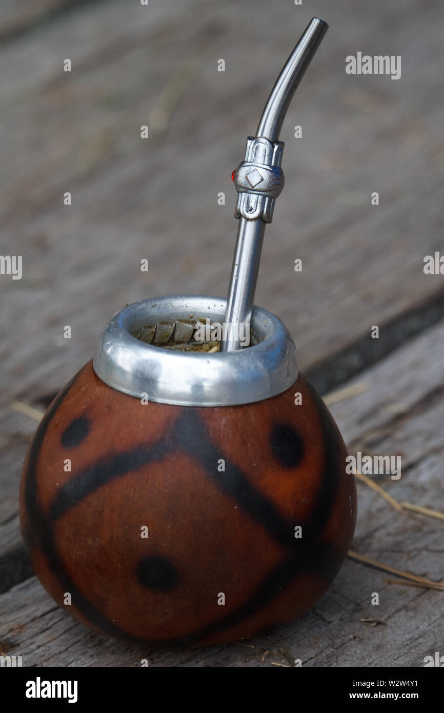 Traditional calabash gourds for yerba mate on the wooden surface, selective focus Stock Photo