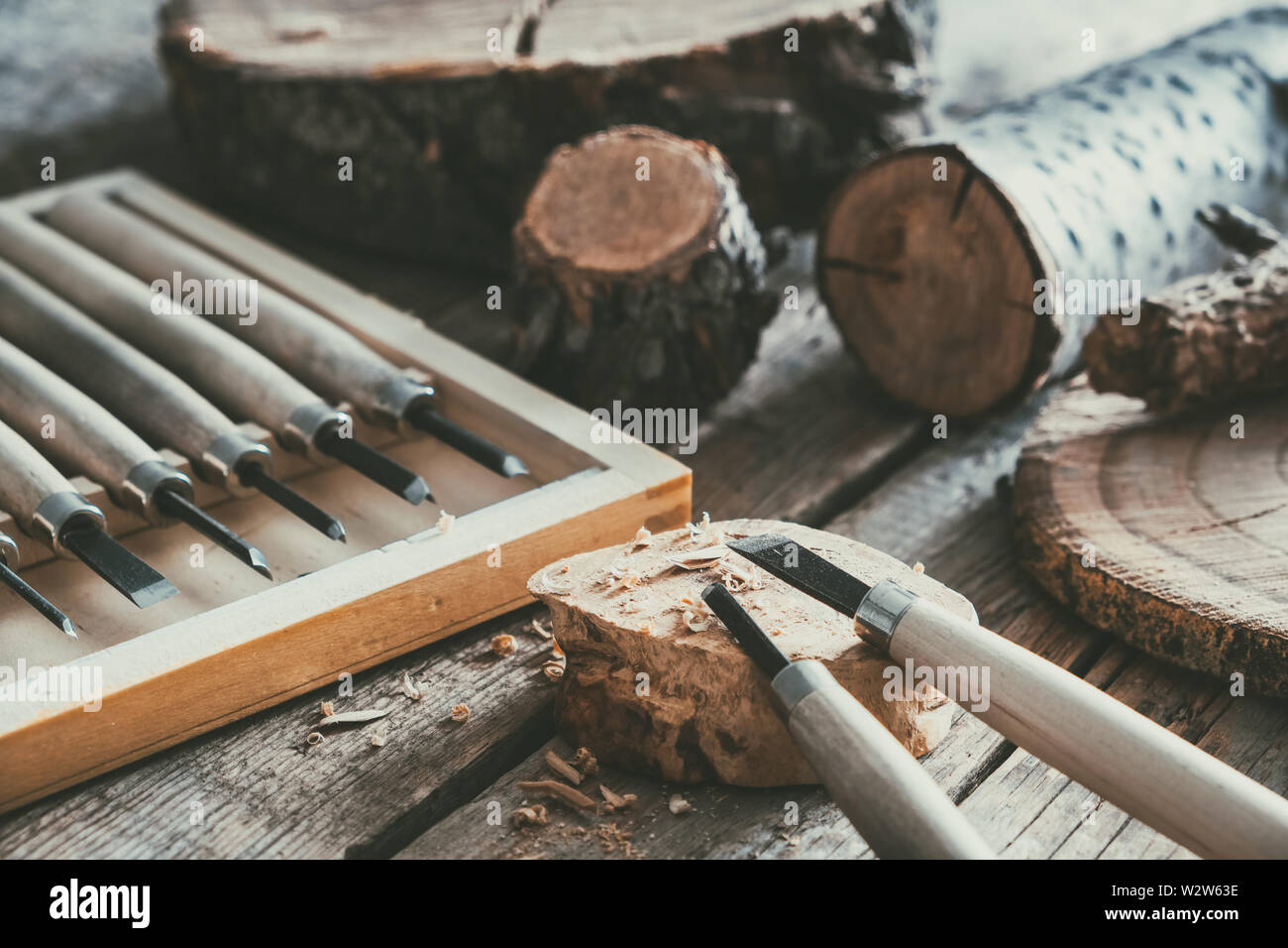 Set of woodworking tools for wood carving and trees cuts on wooden workbench. Stock Photo