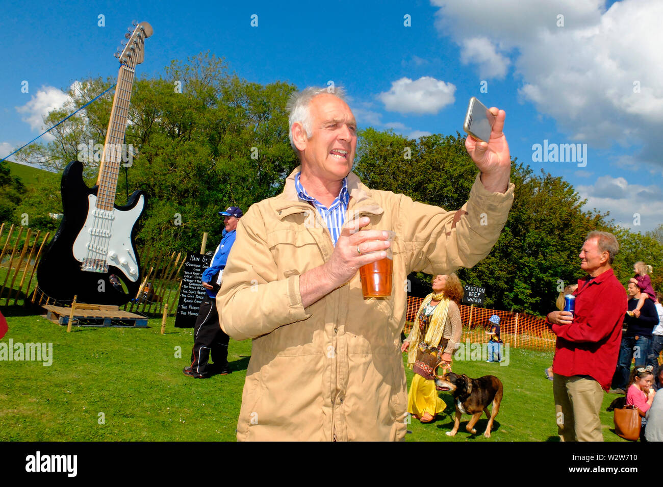 A man taking a selfie at Wolverton Folk and Blues Fair 2019 on the grounds of Wolverton Manor, Shorwell, Isle of Wight, England, UK. Stock Photo