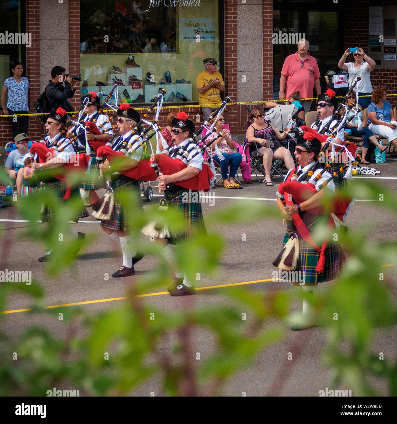Members of the Pipe and Drum band march down the street in Gold Cup