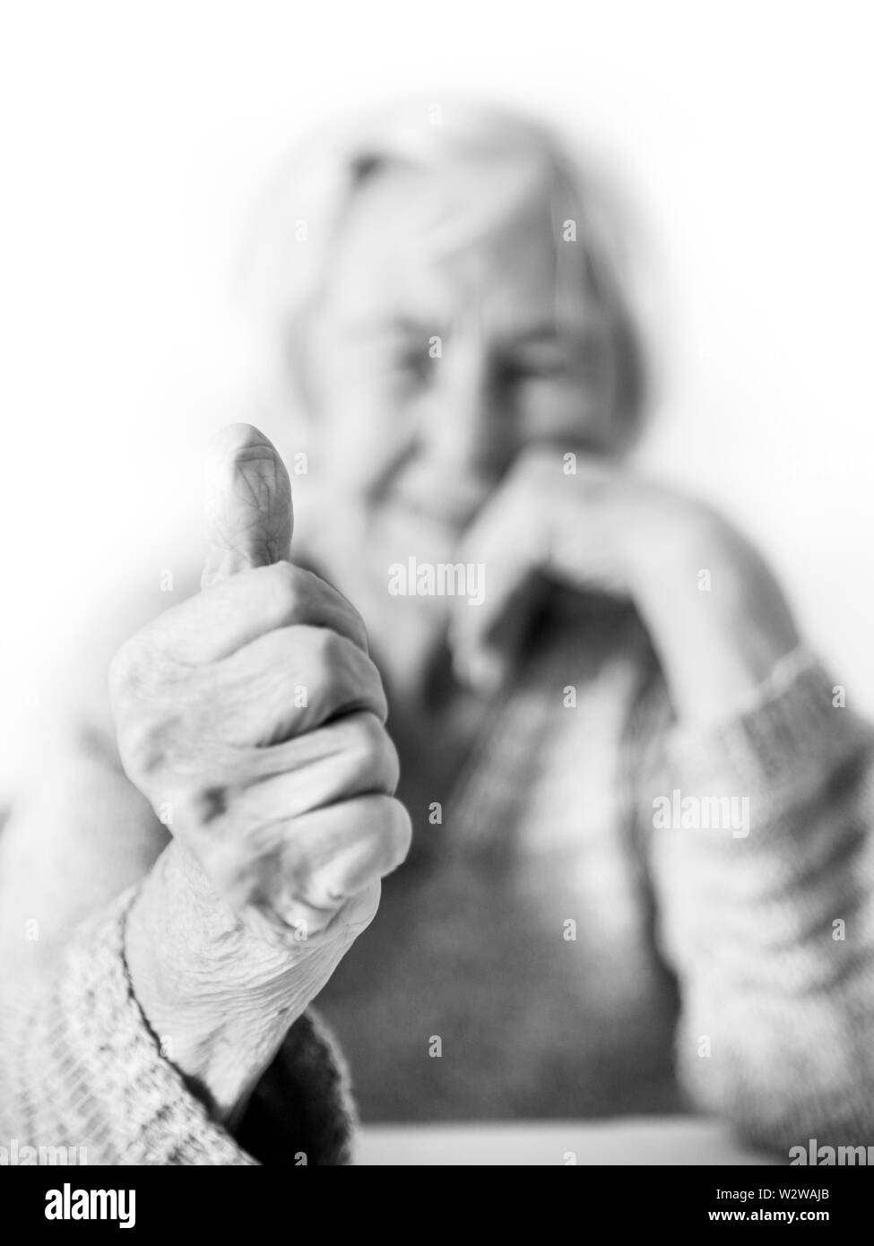 Happy 96 years old elderly woman giving a thumb up and looking at camera. Stock Photo