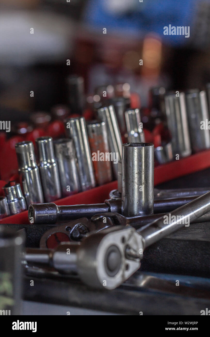 A bunch of wrench sockets on a work bench Stock Photo