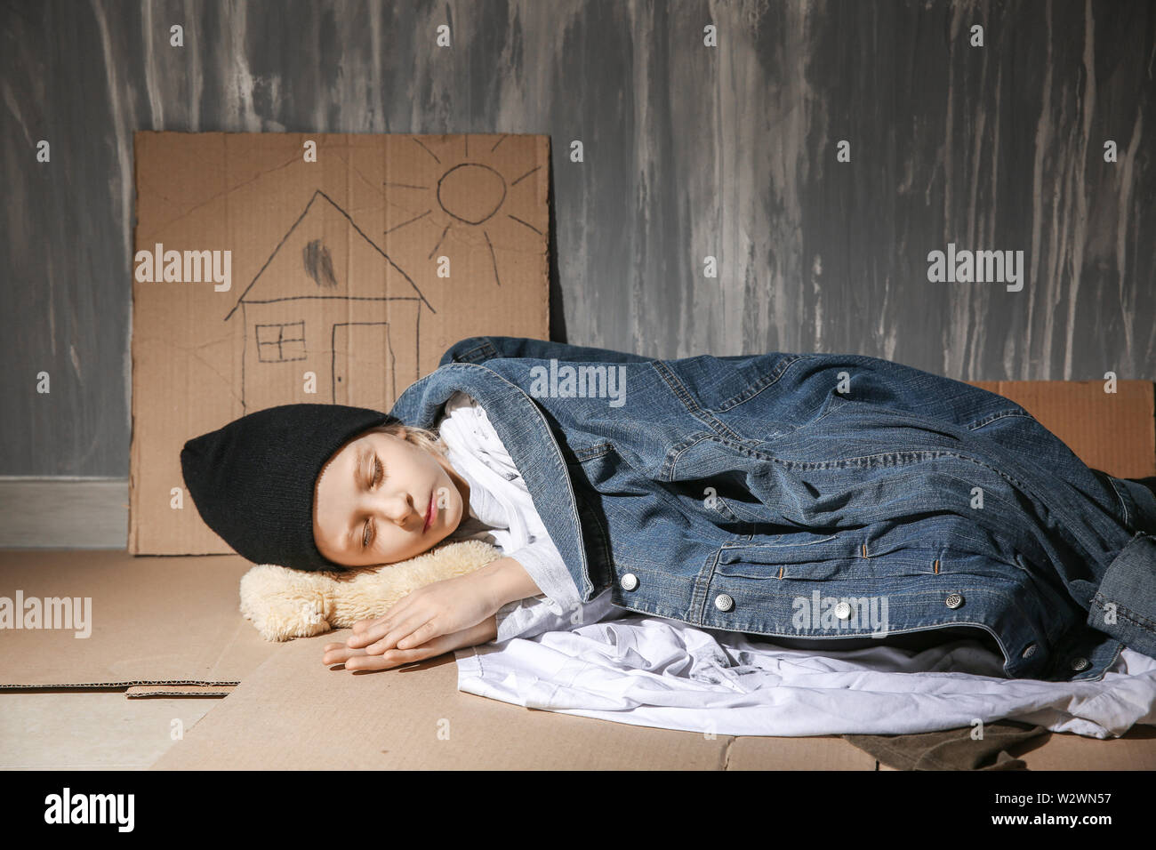 Homeless little girl sleeping on floor near wall Stock Photo Alamy