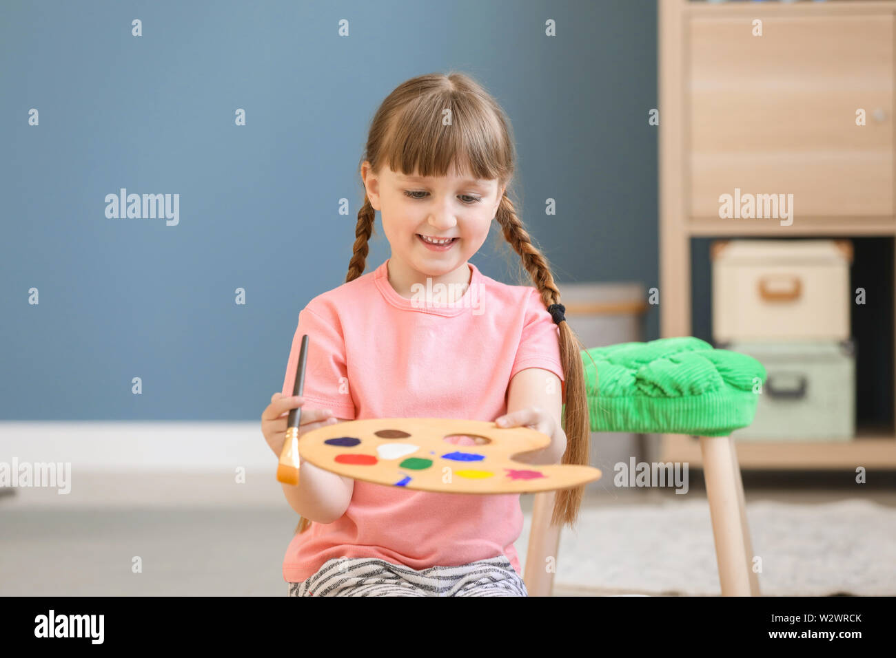 Cute little girl painting at home Stock Photo - Alamy