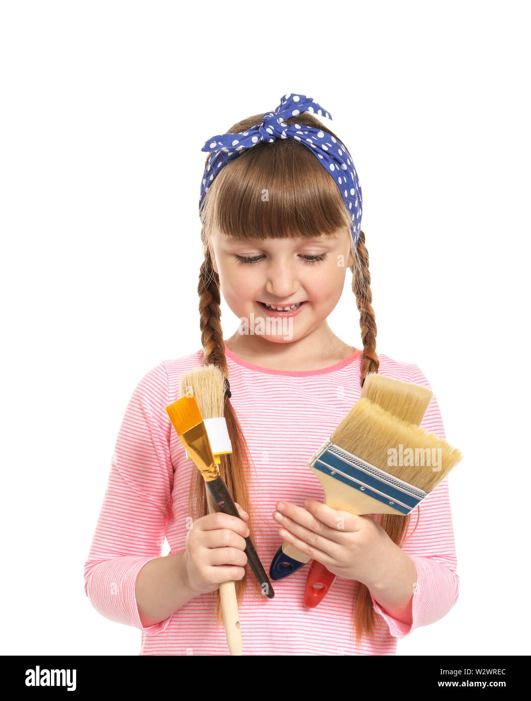 Cute little girl with brushes on white background Stock Photo - Alamy