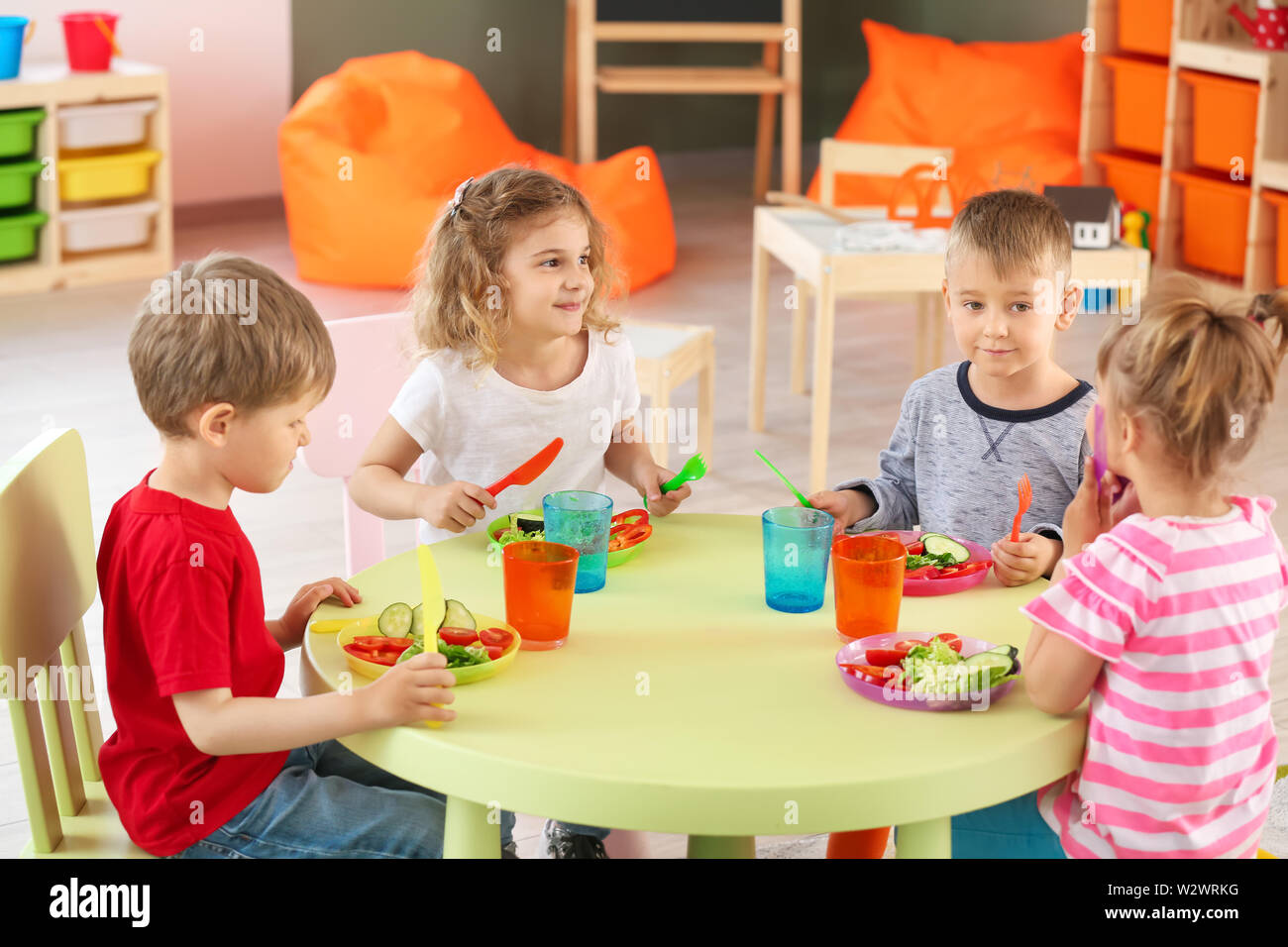 Cute little children eating tasty lunch in kindergarten Stock Photo - Alamy