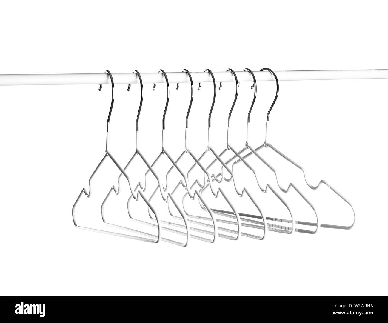 Rack with clothes hangers on white background Stock Photo Alamy