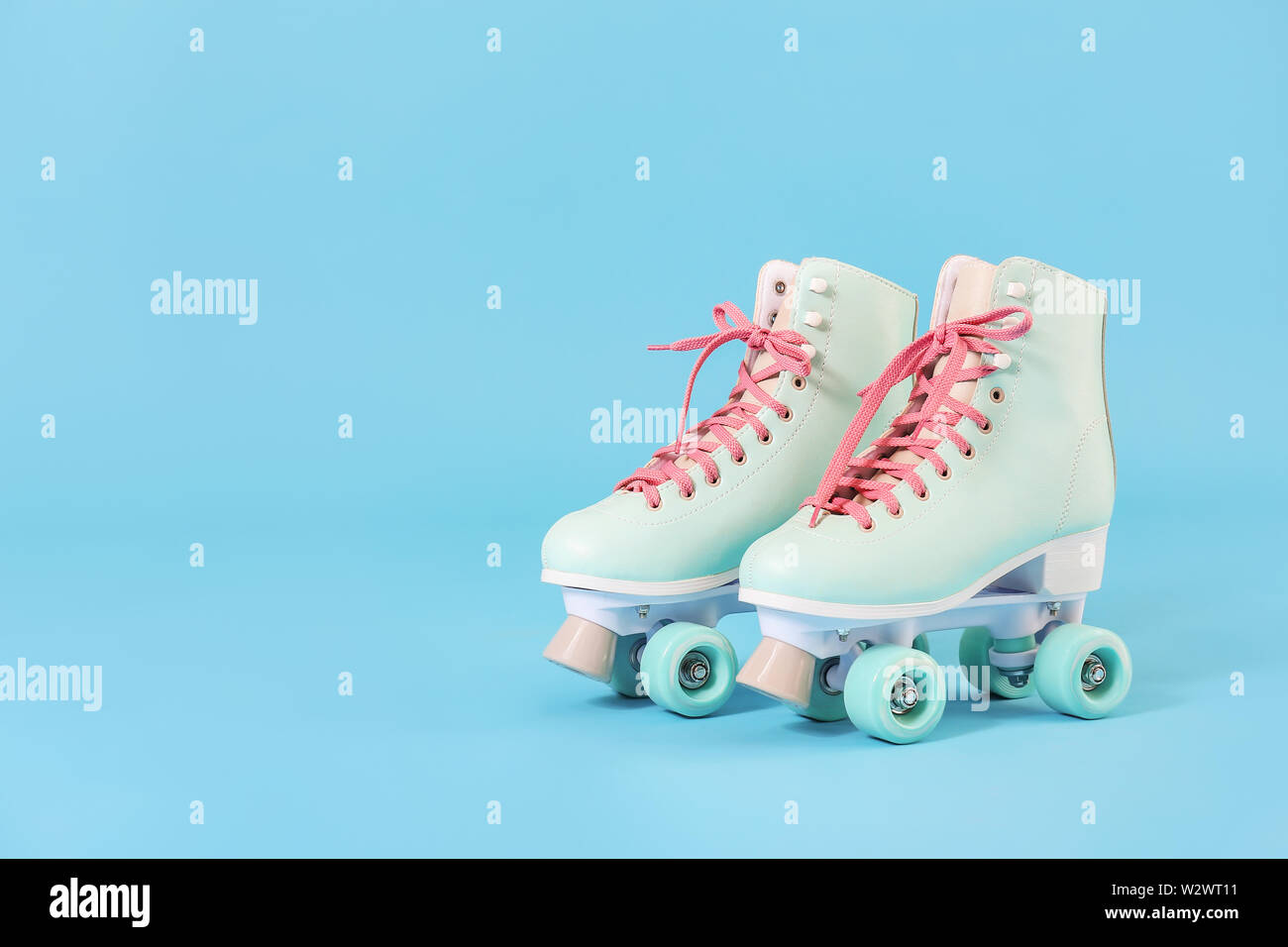 Vintage roller skates on color background Stock Photo - Alamy