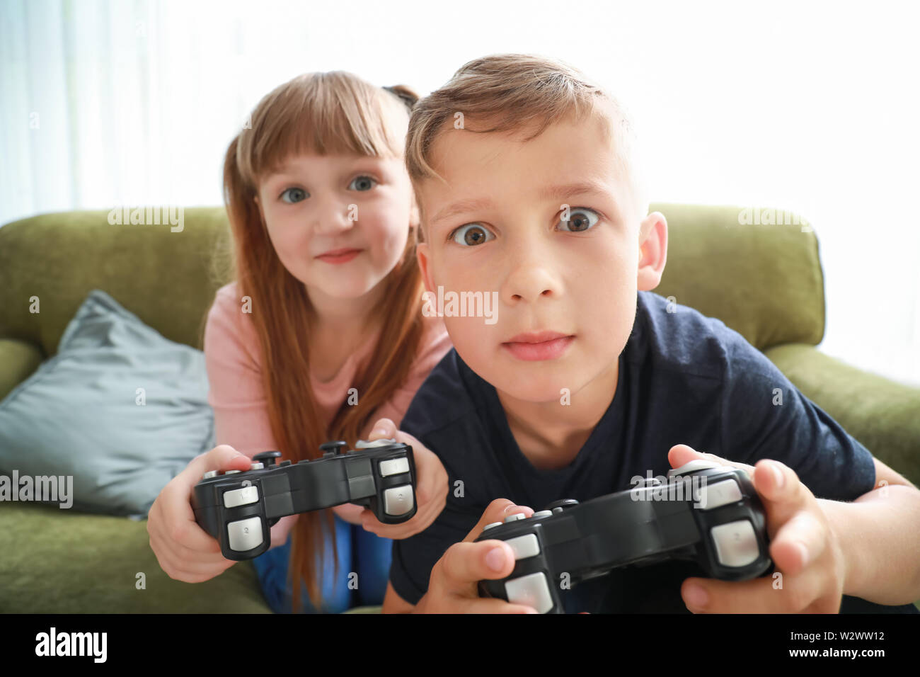 Little children with addiction to video games at home Stock Photo Alamy