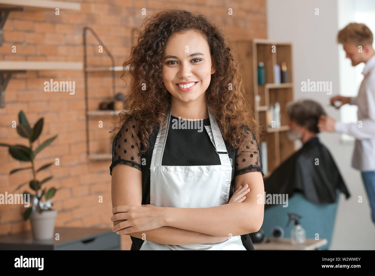 Young African American Hairdresser In Beauty Salon Stock Photo