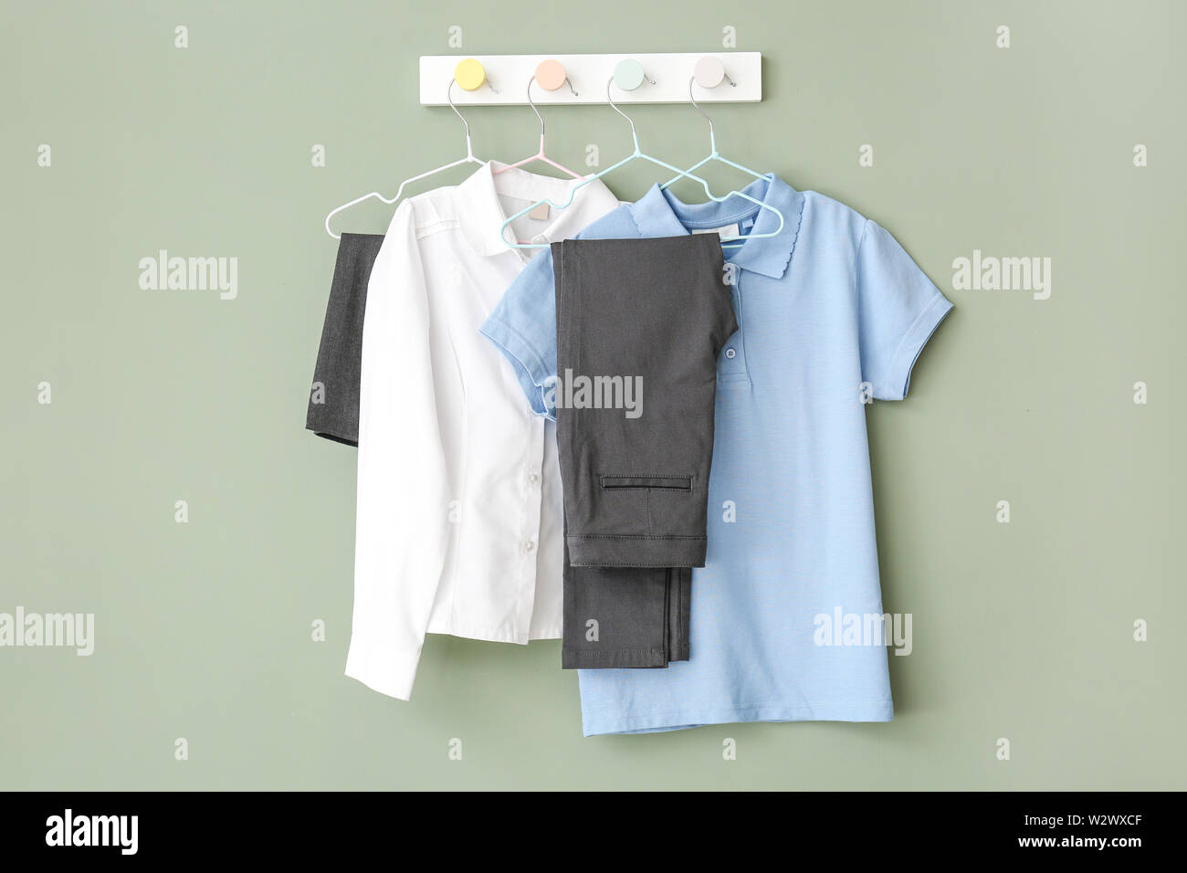 Stylish school uniform hanging on wall Stock Photo - Alamy