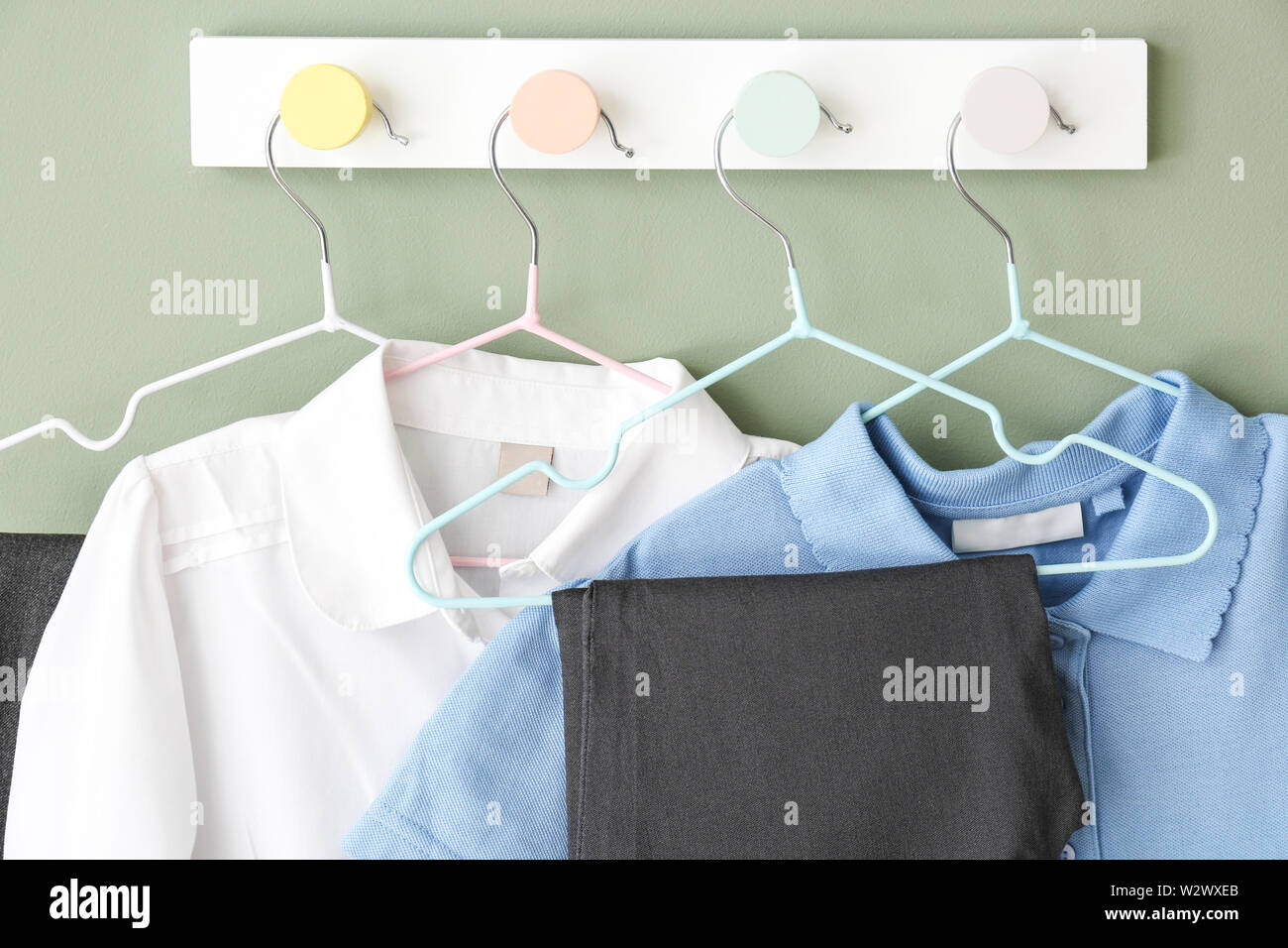 Stylish school uniform hanging on wall Stock Photo Alamy