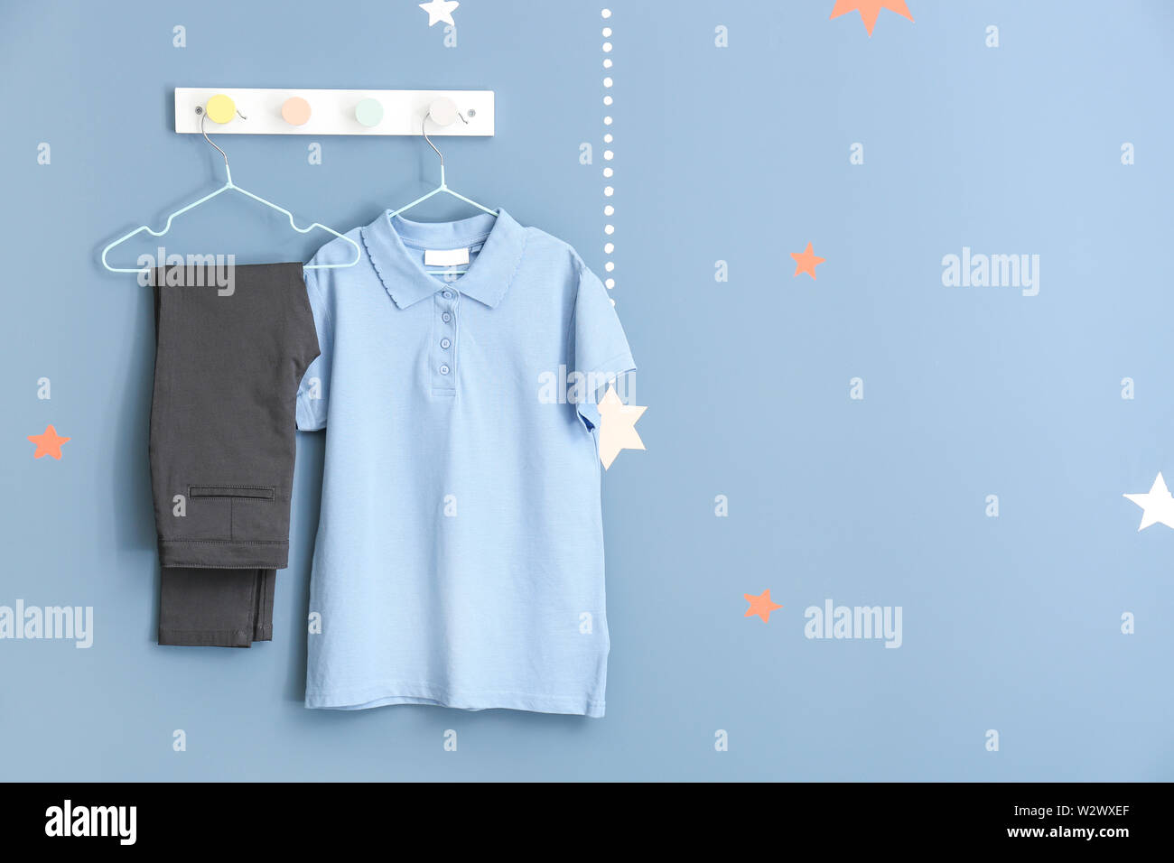 Stylish school uniform hanging on wall Stock Photo Alamy
