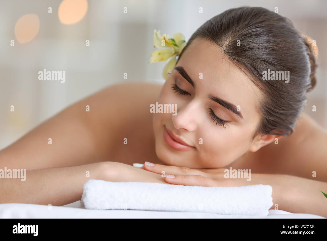 Beautiful young woman relaxing in spa salon Stock Photo - Alamy