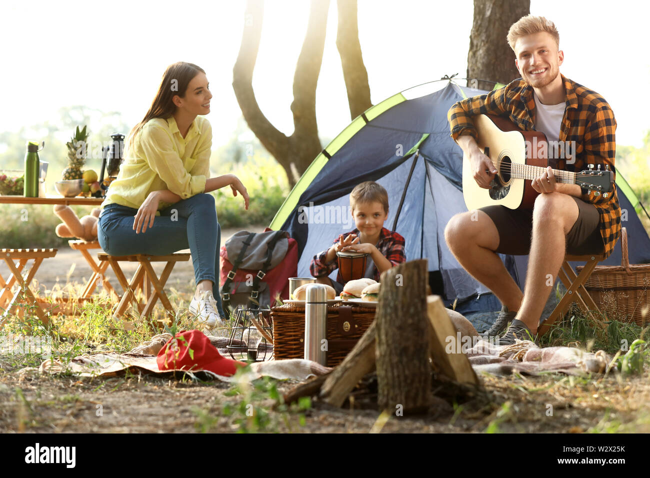 Happy family spending weekend in forest Stock Photo - Alamy